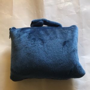 Blue travel blanket or pillow.
